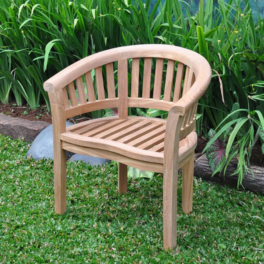 Teak Garden Furniture 150cm Round teak garden table 2 San Francisco benches & 2 San Francisco chairs with curved arms and vertical slats, placed on grass next to lush green plants.