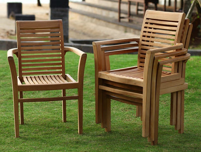 Three Teak 180cm Maximus Round Stacking Sets with 8 Oxford Stacking Chairs on a grassy lawn, arranged two side-by-side and one across from them, with a sandpit in the background.