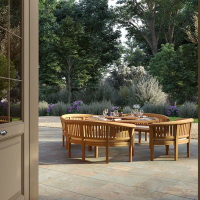 Deluxe 180cm round teak garden table with four San Francisco benches and cream cushions