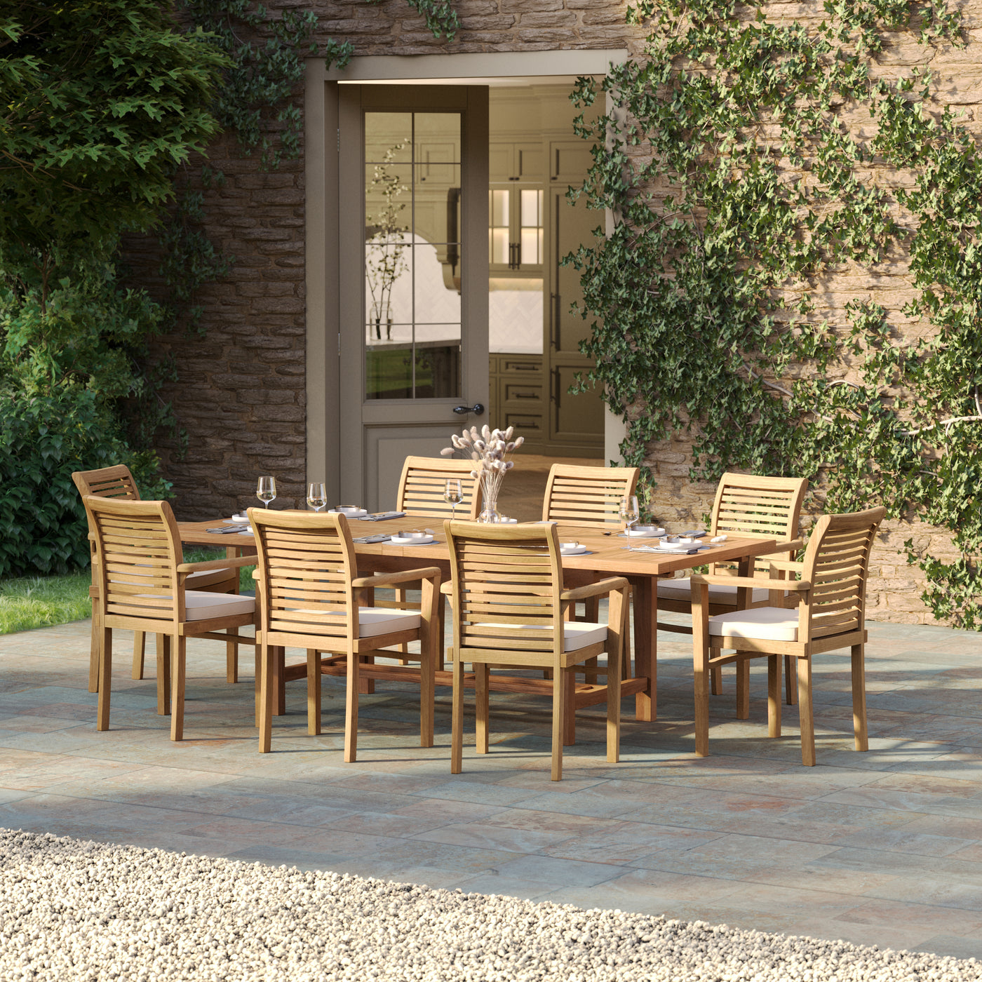 Teak garden dining set displayed on stone patio with green landscape