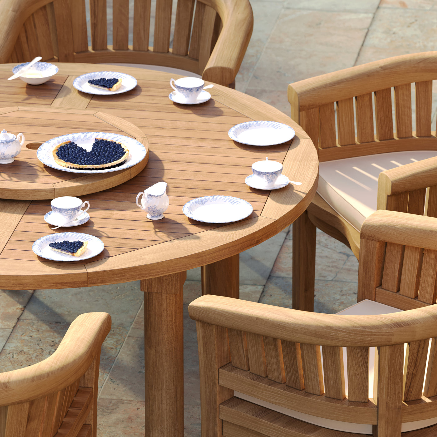 Side view of San Francisco chairs with cream cushions around teak table