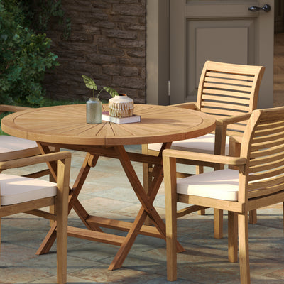 Top view of teak garden furniture set with 120cm round Sunshine table and four Oxford stacking chairs arranged outdoors.