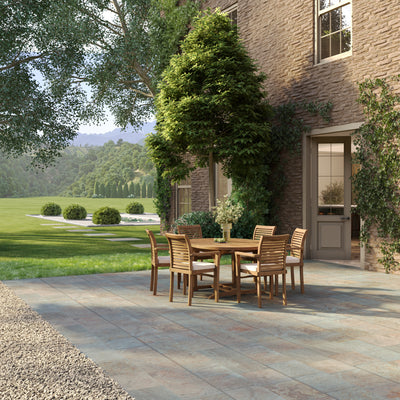 Close-up of teak garden outdoor set showcasing oval extension table detail and Oxford stacking chairs with comfortable cream cushions.